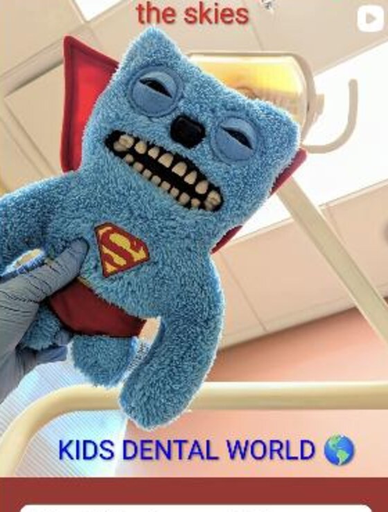 The Kids Dental World tooth mascot wearing a superhero cape